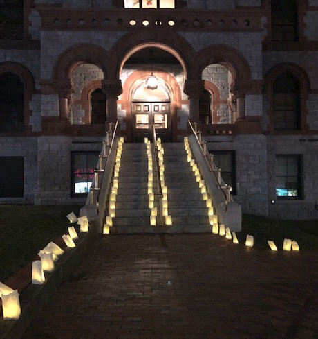 Picture of a church with luminarias shining brightly